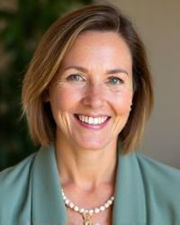 Headshot of Dr. Eleanor Vance, a woman in her late 40s-early 50s with a warm, empathetic smile and kind eyes. She projects calm and wisdom, suitable for a mindfulness coach.